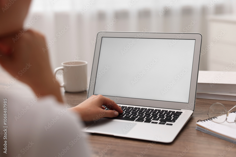 Woman working with laptop at wooden table in office, closeup. Mockup for design Woman working with laptop at wooden table in office, closeup. Mockup for design