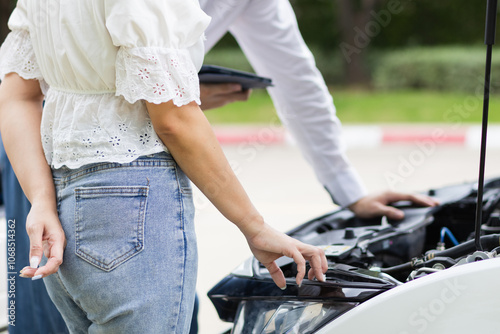 salesman is checking condition of car before delivering it to customer to ensure the quality and service after agreeing to sales contract. concept of checking the condition of the car for confidence photo