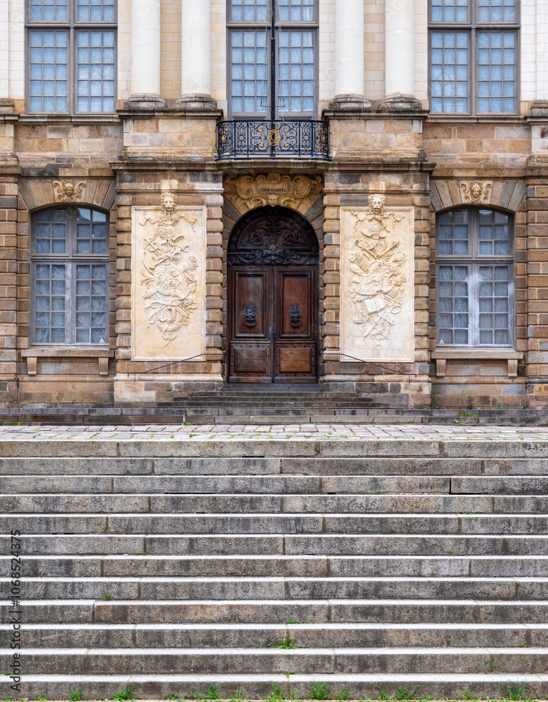 Entrance of a historic parliament building in Rennes with ornate stonework and large windows. Entrance of a historic parliament building in Rennes with ornate stonework and large windows.