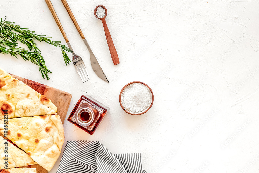 Italian focaccia with cheese and rosemary on white background top-down copy space Italian focaccia with cheese and rosemary on white background top-down copy space