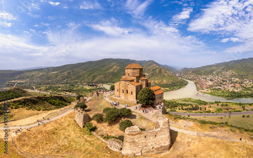 Aerial top view of ancient Jvari Monastery is a VI century Georgian Orthodox monastery. Holy Cross church is Early Medieval Georgian. Confluence of Kura and Aragvi. Tbilisi, Mtskheta, Georgia, Europe. photo