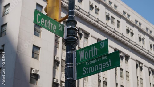 This is a closer look at the street signs located at the intersection of Centre Street and Worth Street in New York.