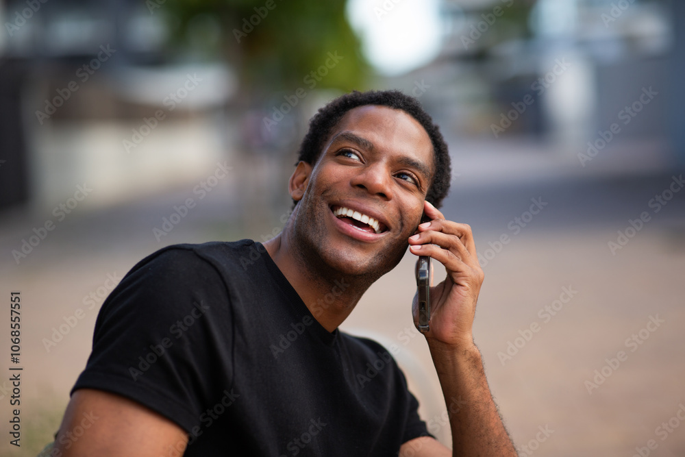 Man smiling while talking on a smartphone outdoors Man smiling while talking on a smartphone outdoors