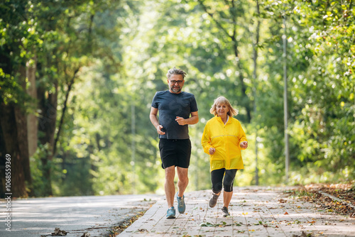 Bright sunlight, jogging, running, sport. Senior couple together outdoors at nature