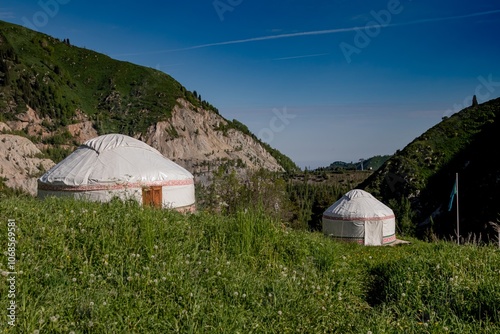 Kazakh national model of a house, a yurt, with a national ornament. There are summer mountains in the background. Kazakhstan, Almaty, Medeo photo