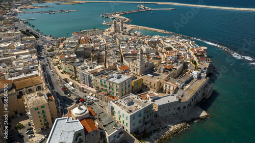 Aerial view of the historic center of Molfetta, in the province of Bari, Puglia, Italy. The Old Town has many churches and is located on the Mediterranean Sea. In background the port of the city.
