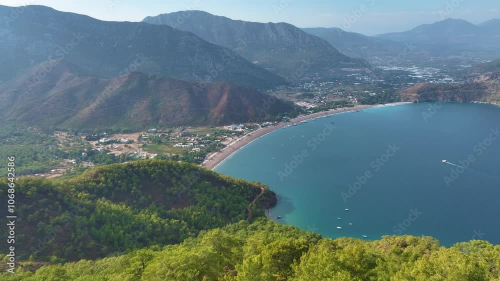 Lush green forests frame stunning turquoise waters of the mediterranean sea, showcasing a charming coastal town nestled among majestic mountains Lush green forests frame stunning turquoise waters of the mediterranean sea, showcasing a charming coastal town nestled among majestic mountains