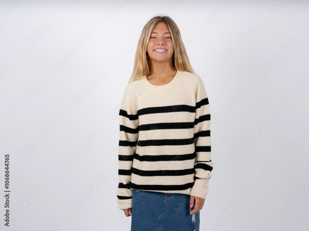 Close up photo of caucasian teen girl wearing striped knitted sweater over white toothy smiling Close up photo of caucasian teen girl wearing striped knitted sweater over white toothy smiling