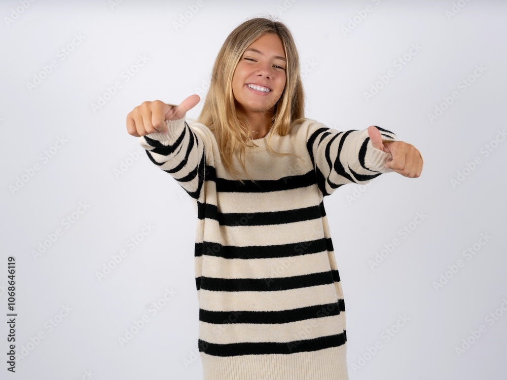 caucasian teen girl wearing striped knitted sweater over white approving doing positive gesture with hand, thumbs up smiling and happy for success. Winner gesture. caucasian teen girl wearing striped knitted sweater over white approving doing positive gesture with hand, thumbs up smiling and happy for success. Winner gesture.