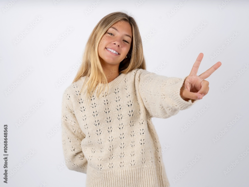 caucasian teen girl wearing knitted sweater over white directs fingers at camera selects someone. I recommend you. Best choice caucasian teen girl wearing knitted sweater over white directs fingers at camera selects someone. I recommend you. Best choice