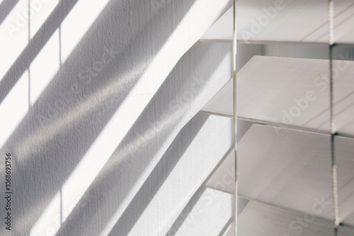 Close-up of white window blinds and shadows