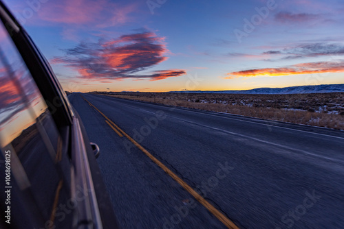 Blurred rural highway seen from moving car at dusk photo