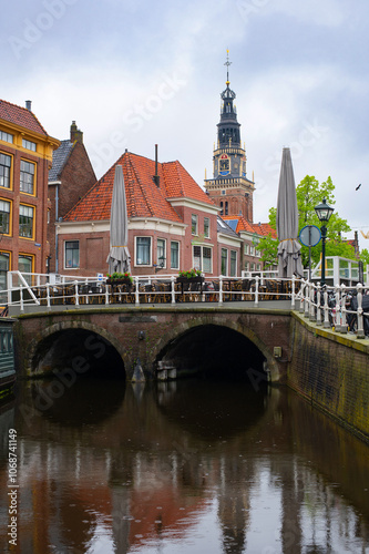 The cityscape of Alkmaar with Gewelfde Stenenbrug bridge over a canal. The Netherlands