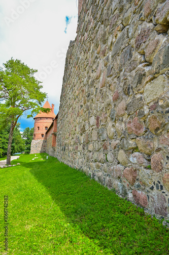 Panorama over the famous Trakai moated castle Trakų salos pilis, on a small island in Lake Galve and Lake Totoriškių in summer under a blue sky, Trakai, Vilnius, Lithuania photo