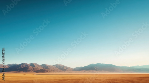 A vast desert landscape featuring mountains under a clear blue sky, showcasing a serene and expansive natural environment. photo