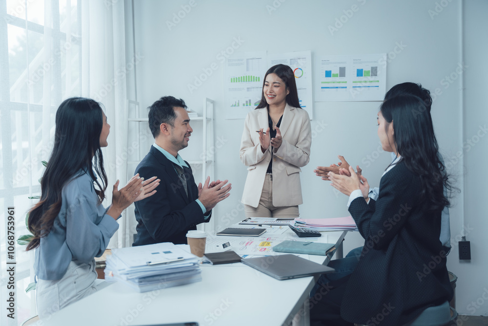 Business Meeting Applause: A diverse team of colleagues applauds a female leader in a modern office setting. A powerful image of unity, success, and recognition in the workplace. Business Meeting Applause: A diverse team of colleagues applauds a female leader in a modern office setting. A powerful image of unity, success, and recognition in the workplace.