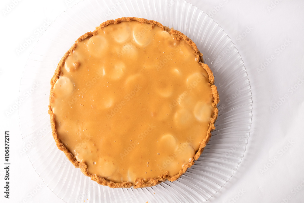 Banoffee banana pie with caramel sauce on the white background. Traditional english cake. Ready to eat. Cooking concept Banoffee banana pie with caramel sauce on the white background. Traditional english cake. Ready to eat. Cooking concept