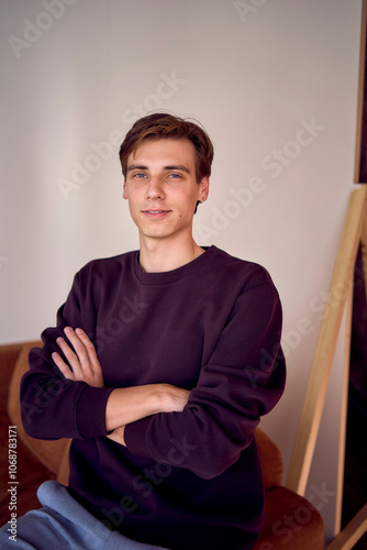 portrait of an attractive young 20 year old man with dark hair and blue eyes, studio photo shoot