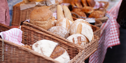 Sourdough bread, freshly baked with a golden crust and a soft, tangy interior.  Available now at our market stall!... in farmer's market. photo