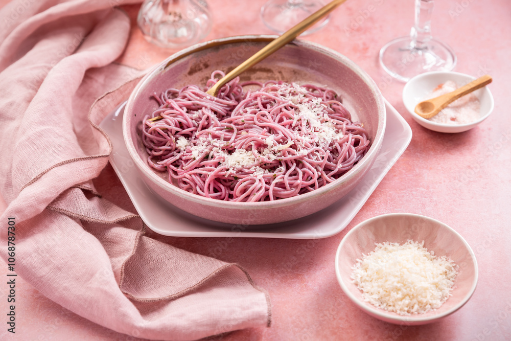 Homemade pink pasta with garlic, lemon and parmesan, naturally colored by red cabbage