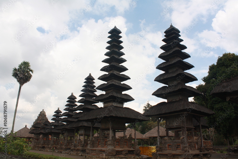 Majestic View of Traditional Balinese Temple with Multi-Tiered Pagodas Under a Cloudy Sky Majestic View of Traditional Balinese Temple with Multi-Tiered Pagodas Under a Cloudy Sky