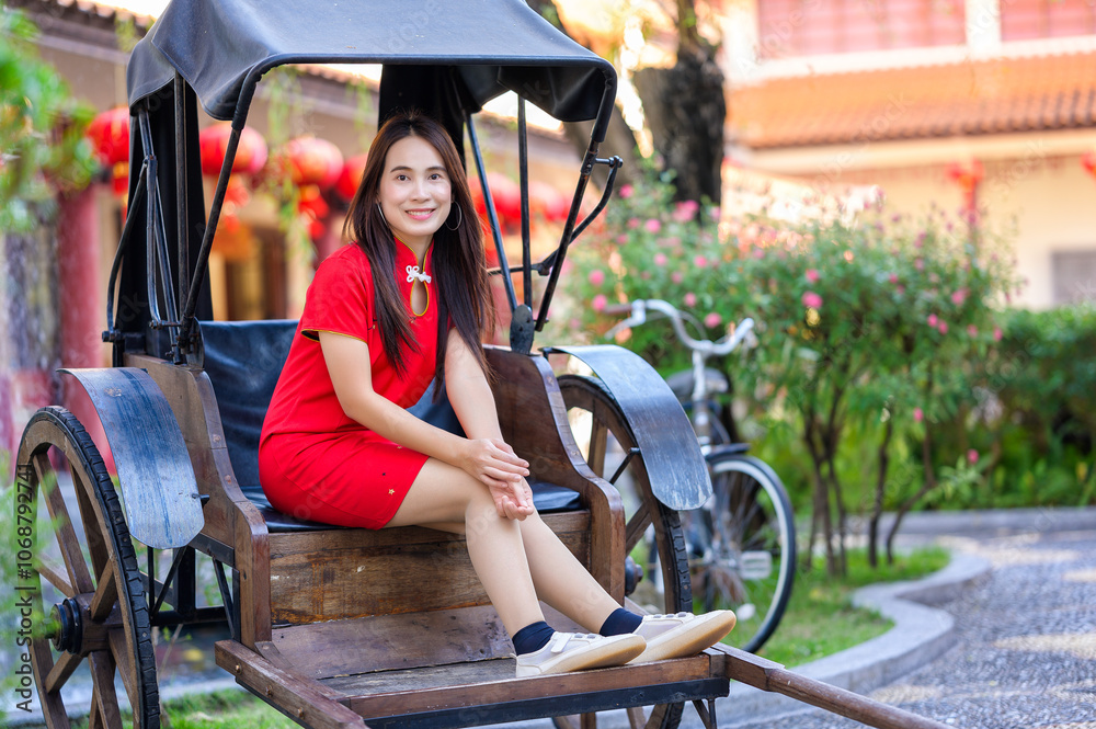 Obraz premium Young Woman in Red Dress Sitting on a Rickshaw