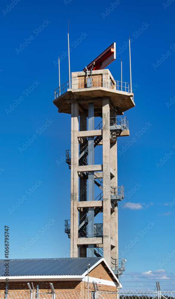 military radar in top of tower against the blue sky military radar in top of tower against the blue sky