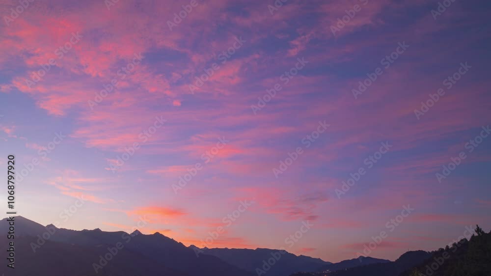 Romantic colorful sunrise above mountain tops. Purple and pink vivid clouds in sky. Concept of beauty world, travel outdoor, natural colorful shots Romantic colorful sunrise above mountain tops. Purple and pink vivid clouds in sky. Concept of beauty world, travel outdoor, natural colorful shots