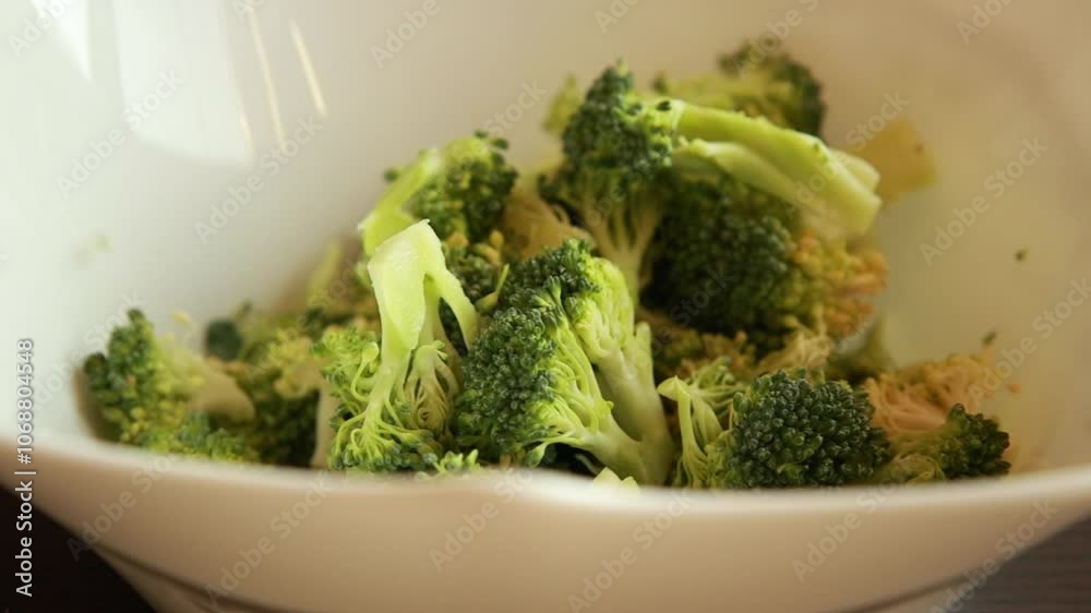 Mixing Fresh Broccoli Florets with Oil and Parmesan - Close-Up Mixing Fresh Broccoli Florets with Oil and Parmesan - Close-Up