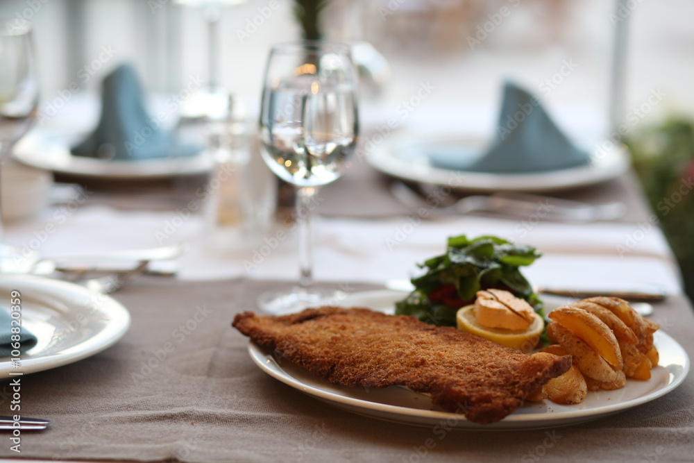 Crispy Wiener Schnitzel with Lemon, Served with Fries and Salad, Classic Austrian Dish, Comfort Food