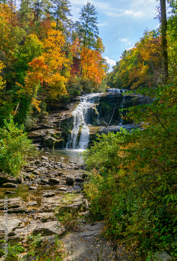 Bald River Falls, Tellico Plains, Tennessee. A waterfall cascades over rocks and is surrounded by rich autumn foliage. Below the falls is a rocky riverbed. Cherohala Skyway, TN. Vertical Bald River Falls, Tellico Plains, Tennessee. A waterfall cascades over rocks and is surrounded by rich autumn foliage. Below the falls is a rocky riverbed. Cherohala Skyway, TN. Vertical