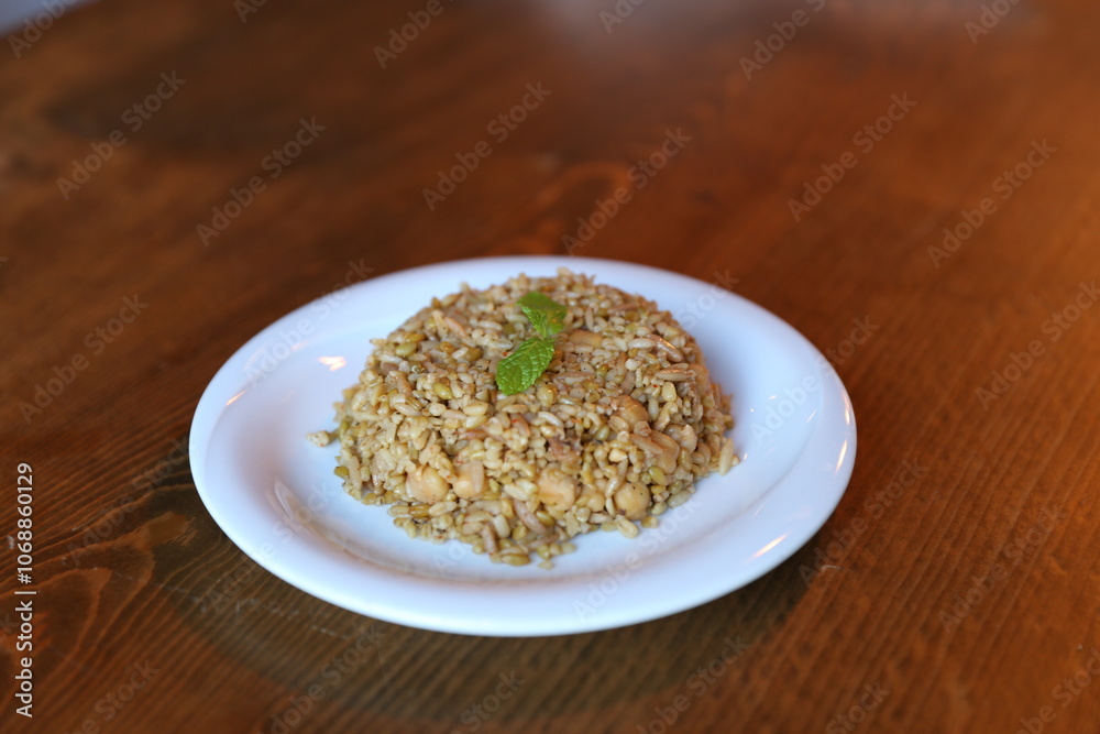 Warm Bowl of Traditional Turkish Bulgur Pilaf with Fresh Mint and Herbs Warm Bowl of Traditional Turkish Bulgur Pilaf with Fresh Mint and Herbs