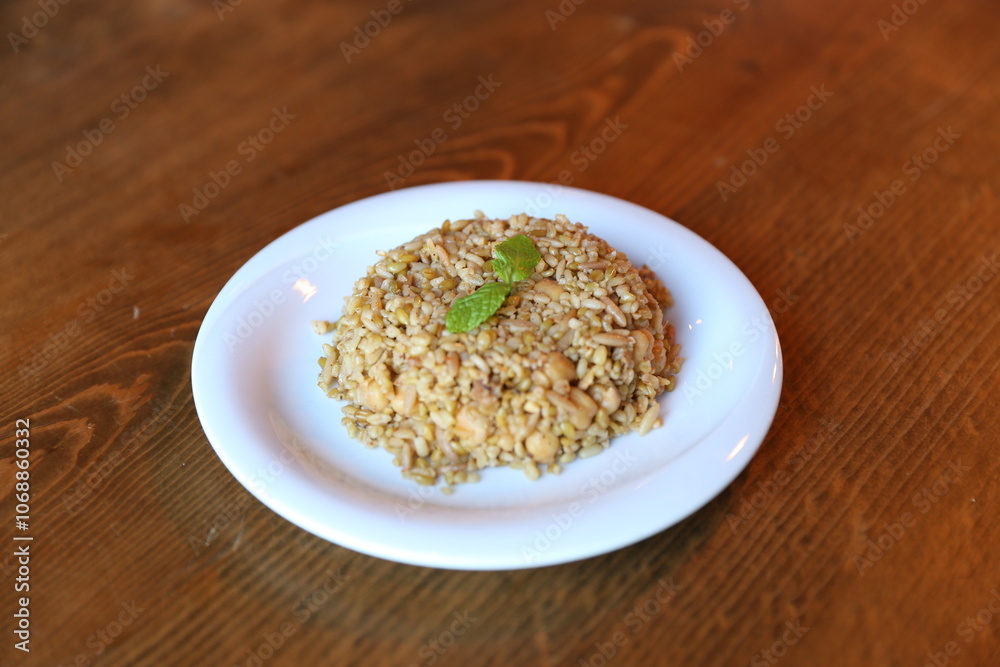 Warm Bowl of Traditional Turkish Bulgur Pilaf with Fresh Mint and Herbs Warm Bowl of Traditional Turkish Bulgur Pilaf with Fresh Mint and Herbs