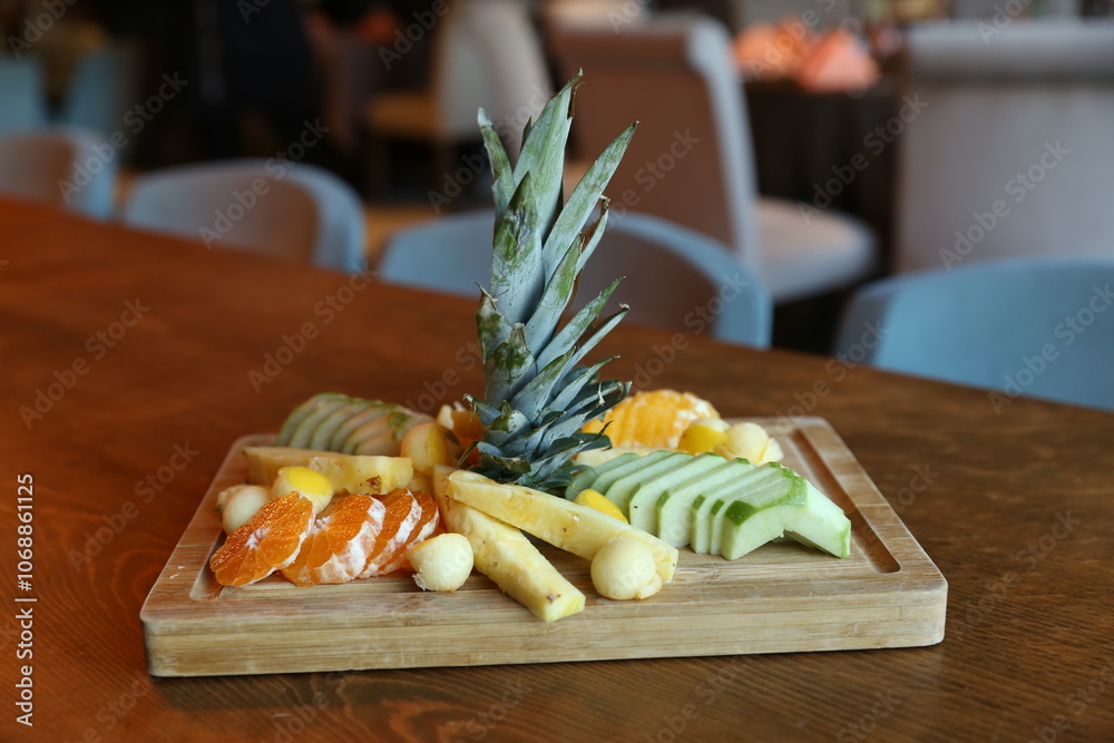 A vibrant and colorful fruit platter with a pineapple centerpiece, perfect for a healthy and refreshing snack