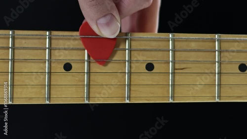 A detailed view of a beautifully crafted wooden guitar fingerboard, showcasing its frets and position markers