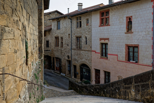 ST-ANTOINE-L'ABBAYE, FRANCE, November 5, 2024 : Main stairway and a street of the medieval village surrounding the Abbey of Saint-Antoine.