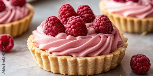 A tartlet filled with a smooth and creamy raspberry mousse, offering a delightful raspberry flavor throughout the luscious cream filling.