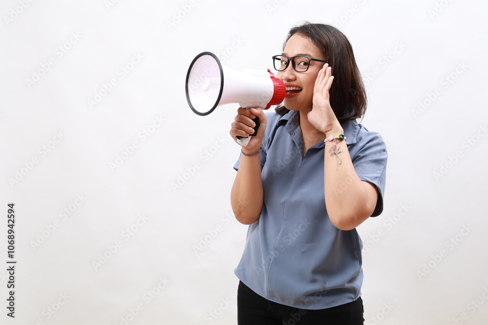 Asian woman screaming while holding megaphone with two hands making announcement Asian woman screaming while holding megaphone with two hands making announcement