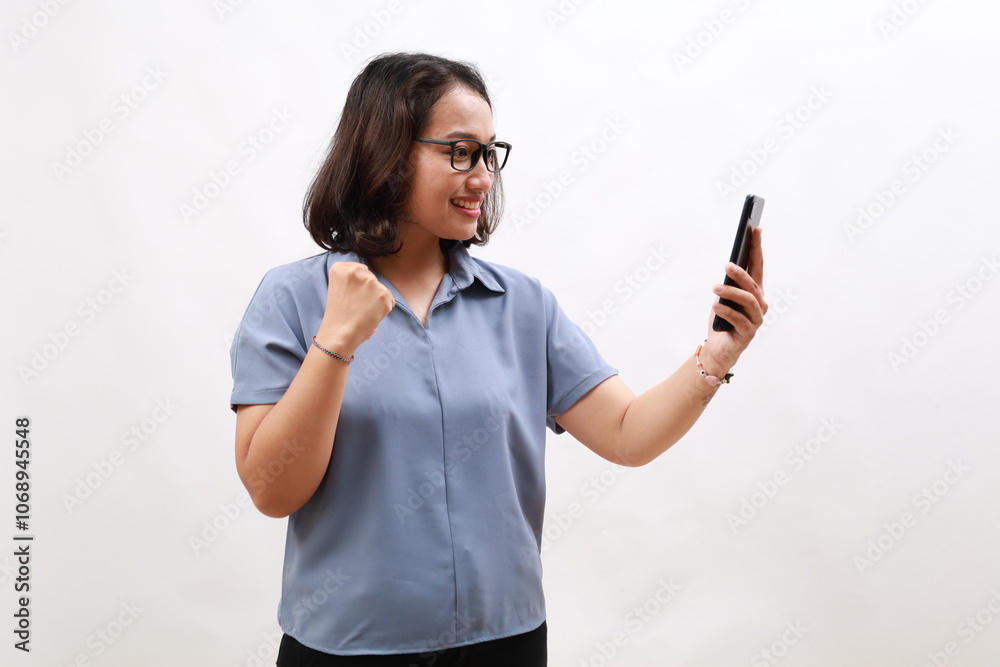 Enthusiastic young asian girl in eyeglasses, holding smartphone, celebrating and dancing, laughing happy with mobile phone, standing over white background Enthusiastic young asian girl in eyeglasses, holding smartphone, celebrating and dancing, laughing happy with mobile phone, standing over white background