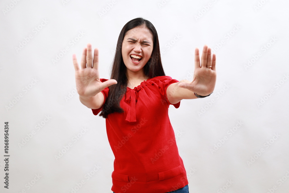 Young asian woman in red afraid and terrified with fear expression stop gesture with hands, shouting in shock. panic concept. Young asian woman in red afraid and terrified with fear expression stop gesture with hands, shouting in shock. panic concept.