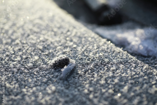 Close-Up Photograph of Frost on Asphalt Surface in Winter Morning Light photo