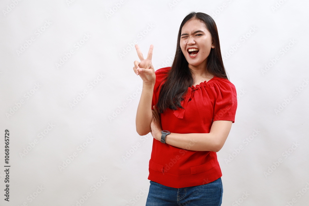 Young woman wearing casual red shirt smiling with happy face winking at the camera doing victory sign. number two.