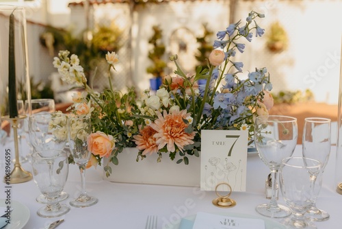 Quadro su tela Floral centerpiece featuring peach, yellow, blue, and white flowers in a rectangular vase