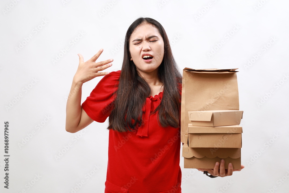 Pretty hispanic woman feeling stressed, anxious, tired and frustrated and holding take away fast food boxes Pretty hispanic woman feeling stressed, anxious, tired and frustrated and holding take away fast food boxes