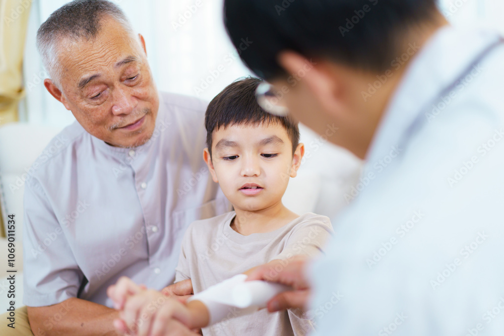 The boy got an accident on his arm then grandfather is taking him to see a doctor. The boy got an accident on his arm then grandfather is taking him to see a doctor.