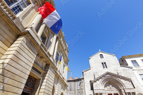 ARLES, FRANCE: mairie de la ville d'Arles, entrée principale avec drapeau francais et Cathédrale Saint-Trophime, Provence, Sud-Est de la France photo