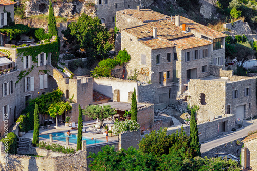 GORDES, PROVENCE, FRANCE - JULY 7, 2012: luxury holiday home with swimming pool, in one of the most beautiful villages in France, traditional stone house with terracotta roof tiles called a 