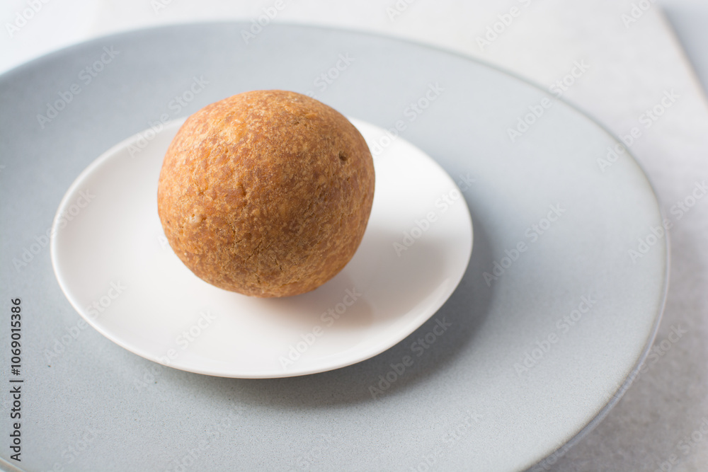 homemade nigerian egg roll on a white background, freshly made african egg roll on a white plate, egg wrapped in fried dough homemade nigerian egg roll on a white background, freshly made african egg roll on a white plate, egg wrapped in fried dough