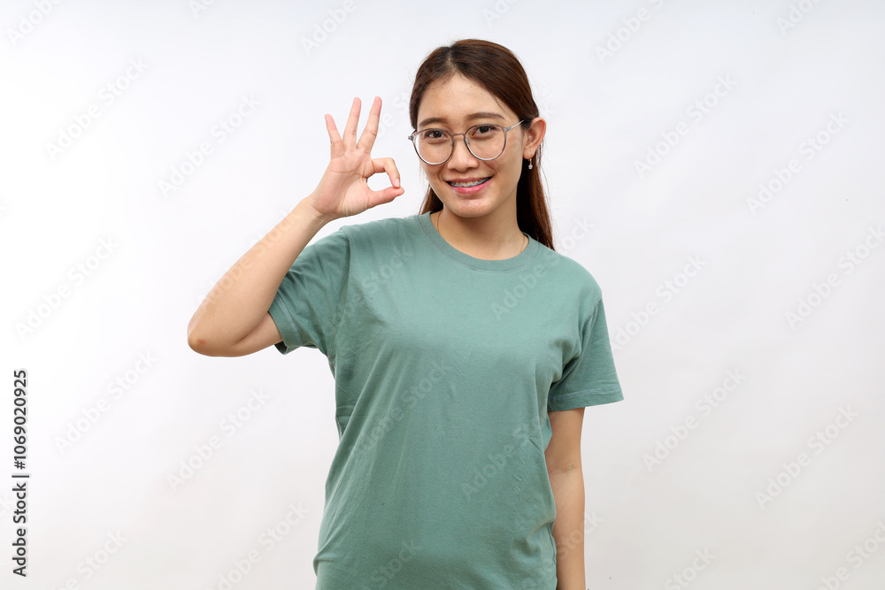 Smiling asian woman showing okay, Very good with satisfied face expression, praise and compliment great job, pleased standing over white background Smiling asian woman showing okay, Very good with satisfied face expression, praise and compliment great job, pleased standing over white background