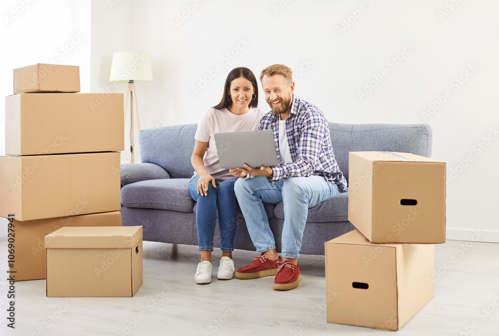 Married couple enjoying time together while relocating to a new home. Use a laptop during the moving process, happy as they manage real estate transition and embrace the joy of new living space. Married couple enjoying time together while relocating to a new home. Use a laptop during the moving process, happy as they manage real estate transition and embrace the joy of new living space.